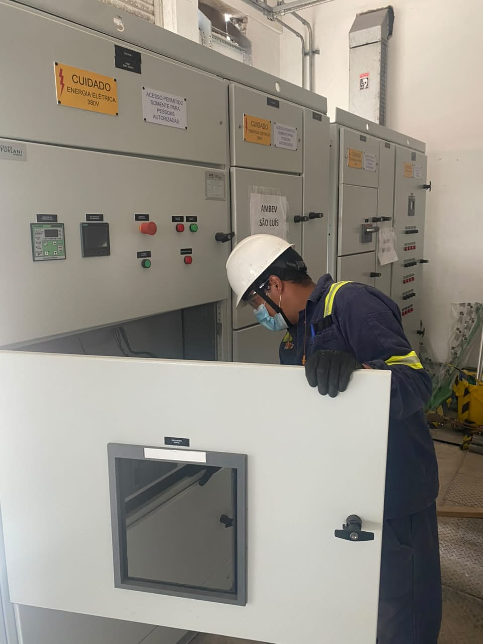 Técnico realizando inspeção em painéis elétricos industriais
